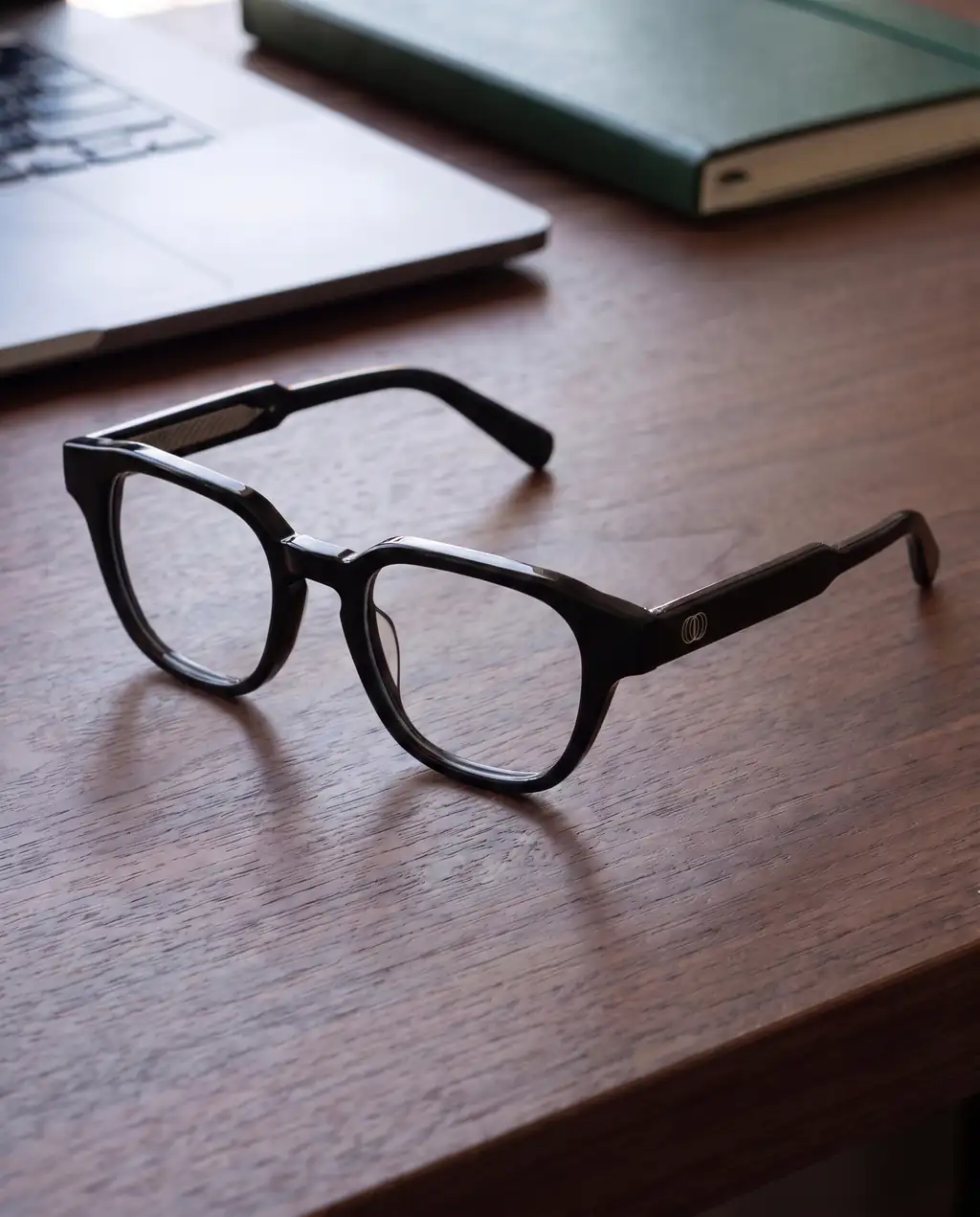 Origo Clear lens, black frame — on a desk