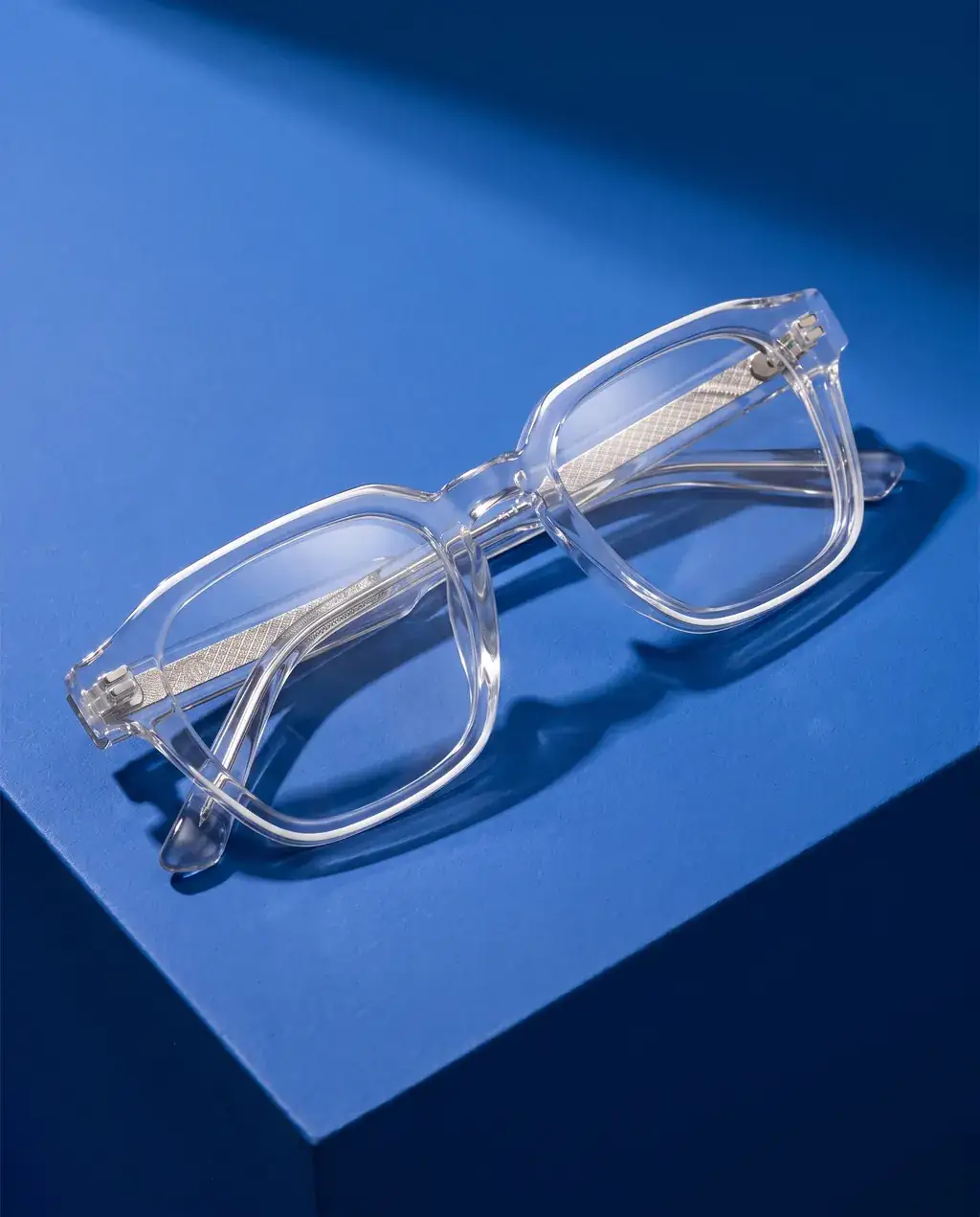 Origo Clear lens, transparent frame — on blue