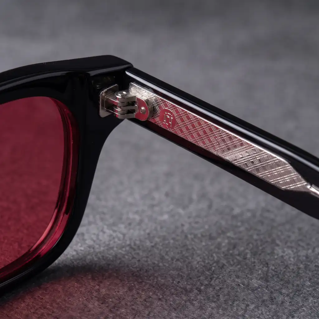 Origo Red lens, black frame — the hinge and the temple inlay