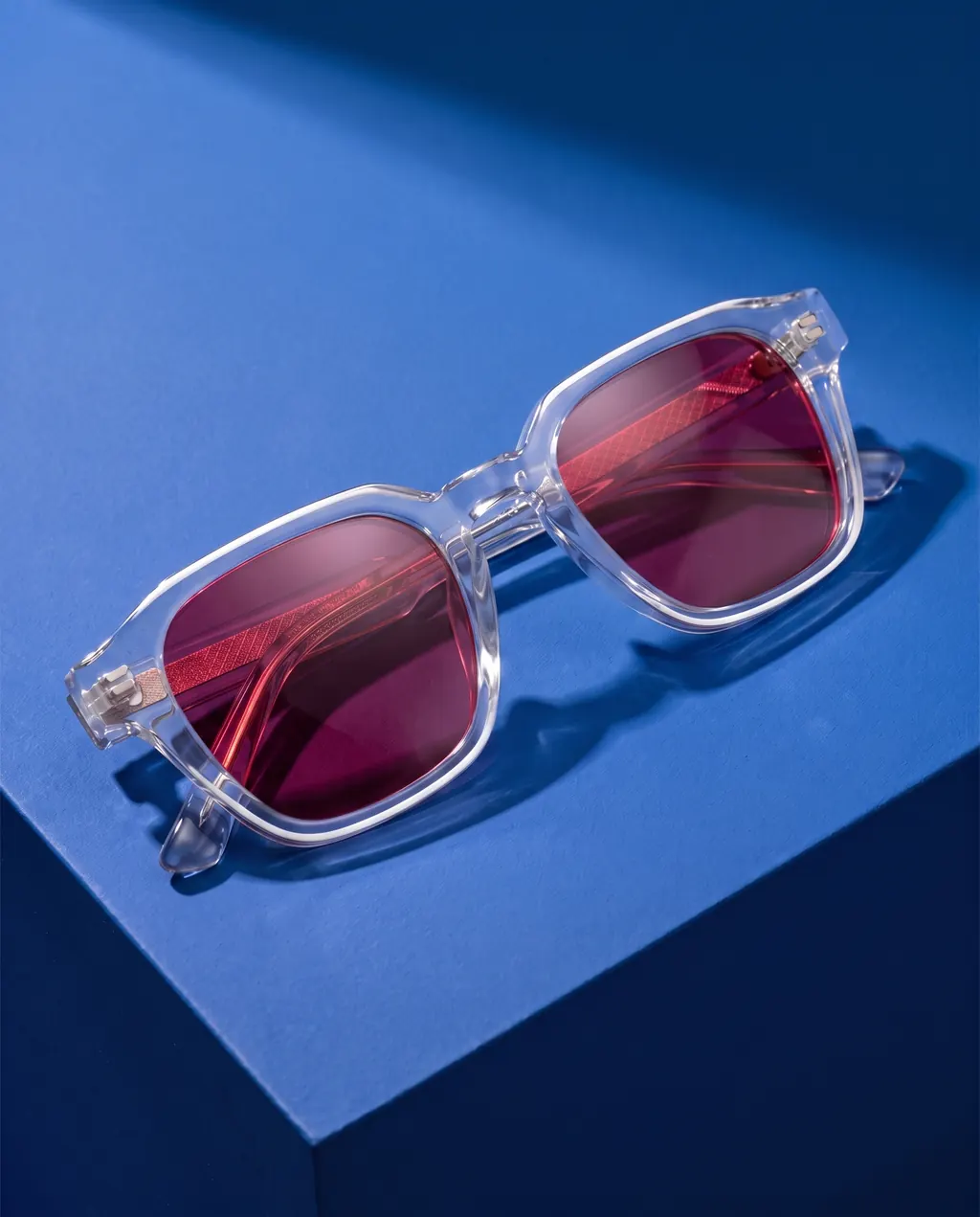 Origo Red lens, transparent frame — on blue