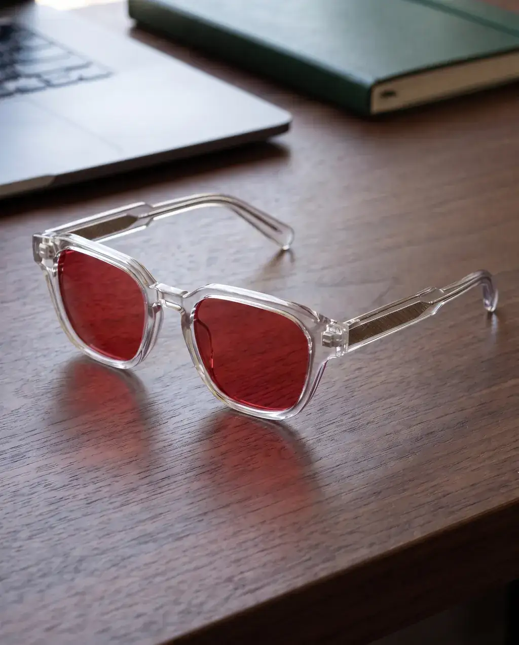 Origo Red lens, transparent frame — on a desk