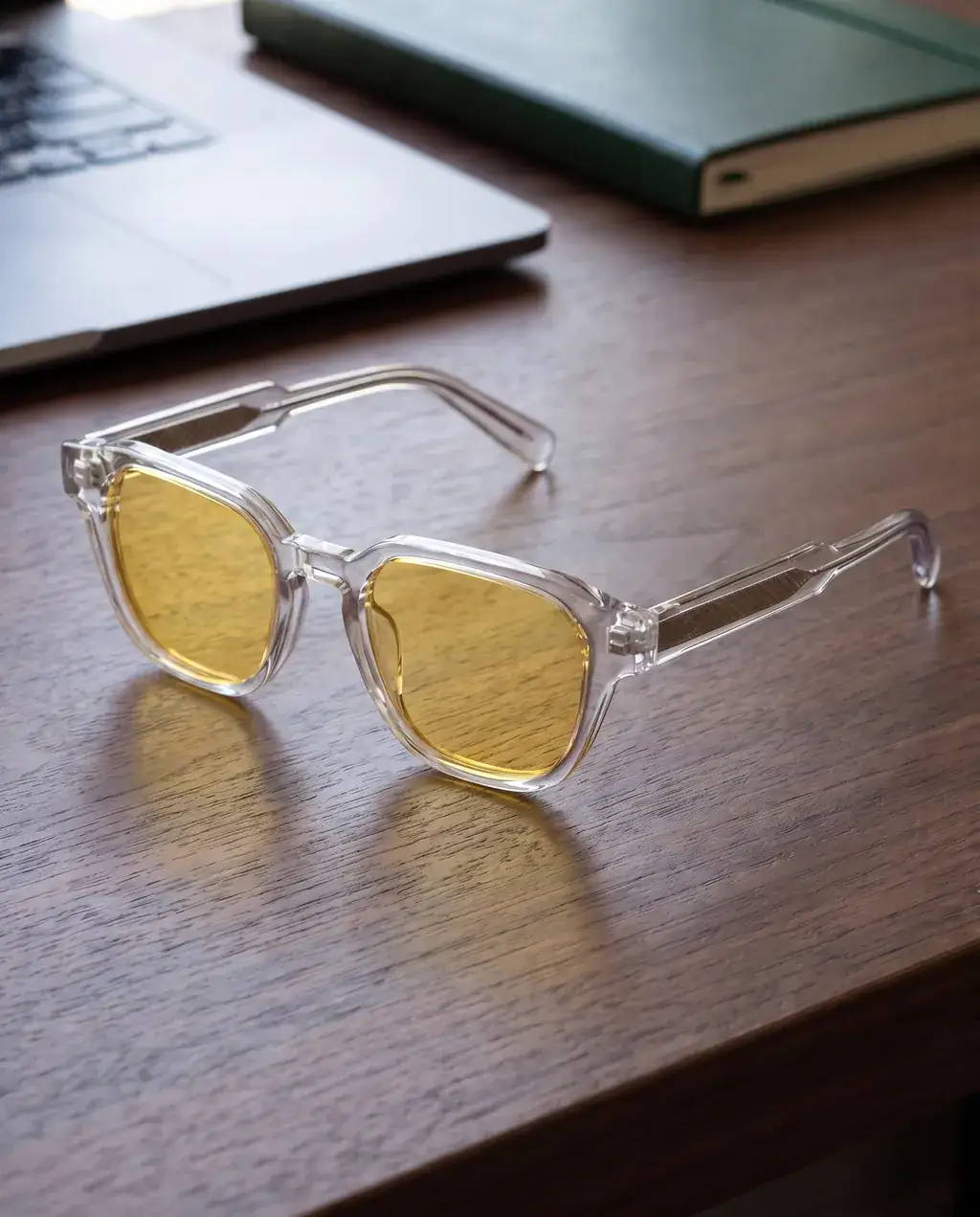 Origo Yellow lens, transparent frame — on a desk